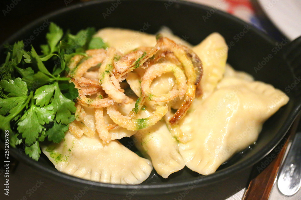 Delicious dumplings with cheese and onions in a bowl Delicious dumplings with cheese and onions in a bowl