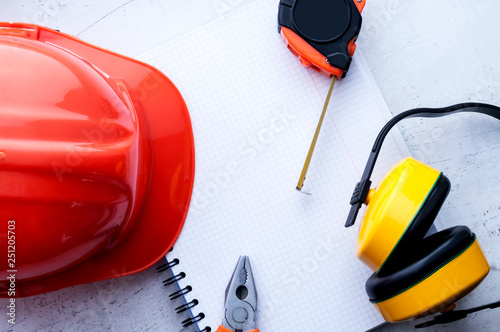 Construction helmet is a symbol of safety in the workplace. Set of tools. Safety concept Selective focus.