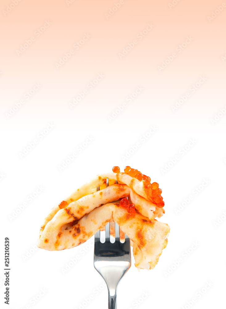 Thin russian pancake with red caviar impaled on a fork on a white background Thin russian pancake with red caviar impaled on a fork on a white background