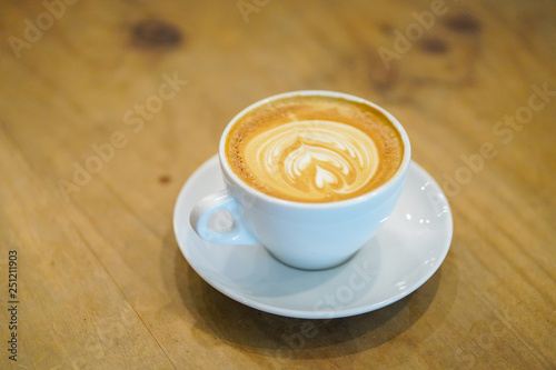 Cups of latte art on wooden table background, Top view.