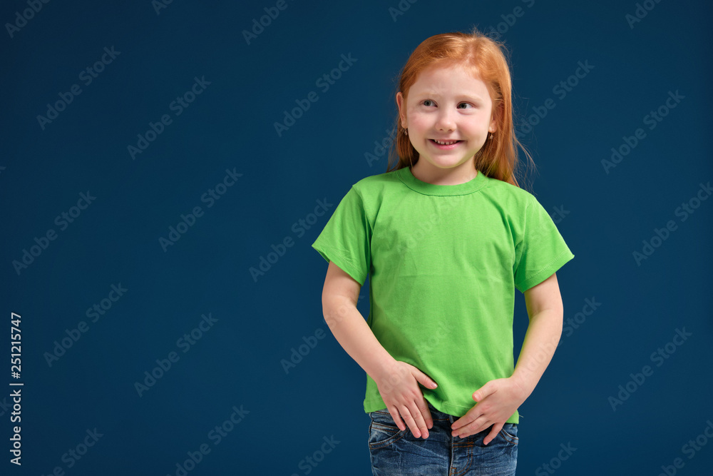close up photo of little redhead emotional girl posing before camera on blue background close up photo of little redhead emotional girl posing before camera on blue background