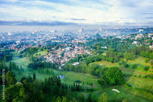 Golf course with dense houses in Bandung city