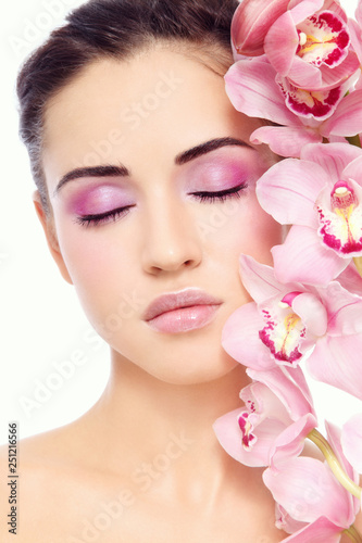 Young beautiful woman with pink make-up and orchid