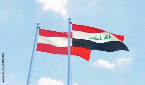Iraq and Austria, two flags waving against blue sky. 3d image