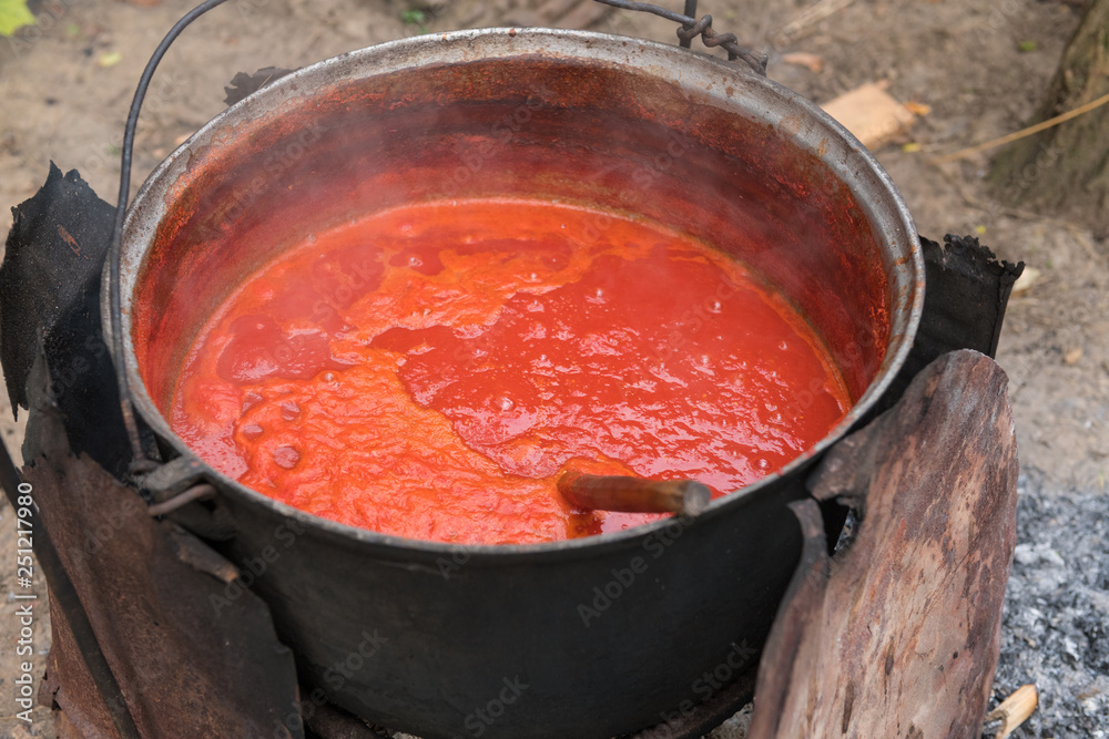 Making tomato sauce the old fashioned way in a large pot. Making tomato sauce the old fashioned way in a large pot.