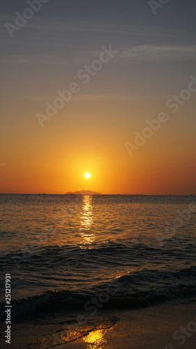 Bright sunset under the sea with yellow red gradient colors - Vertical