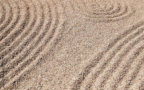 Zen patterns on the sand in stone garden