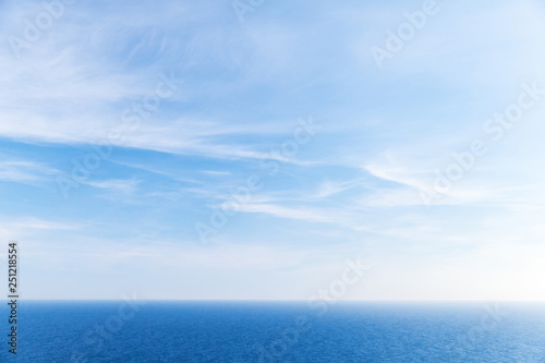 Blue sky background, clouds over ocean © evannovostro