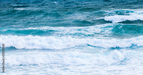 Fototapeta Naklejka Na Ścianę i Meble -  Blue sea water with foam of shore waves