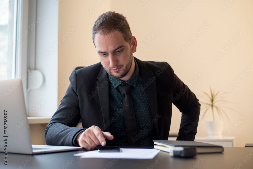 businessman in office sending messages with mobile phone smiling businessman in office sending messages with mobile phone smiling