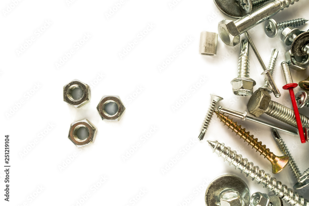 Flat lay of nuts isolated on white. Self Drilling screws. Isolated fasteners. Connecting material on white background Flat lay of nuts isolated on white. Self Drilling screws. Isolated fasteners. Connecting material on white background