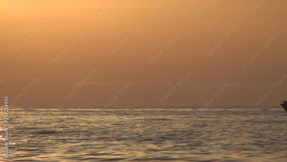 Mediterranean Seascape with a Small Fishing Boat Sailing in a Sunset Red Light Mediterranean Seascape with a Small Fishing Boat Sailing in a Sunset Red Light