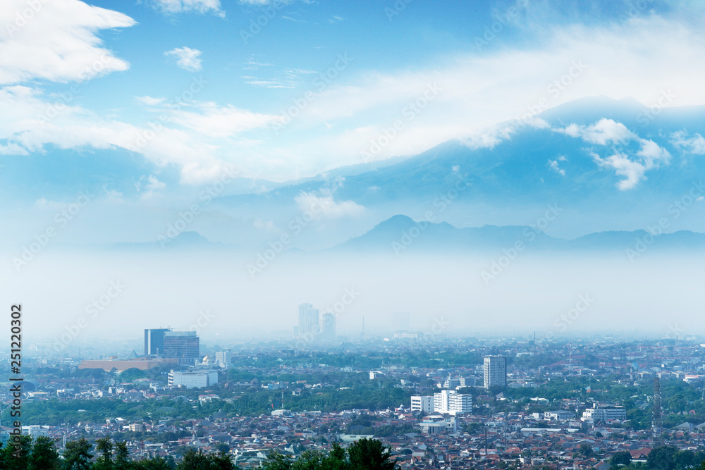 Wonderful Bandung cityscape with misty mountain