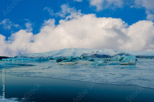  Frozen wonderland in scenic Iceland, with clouds blue sky and a mountain of snow and ice