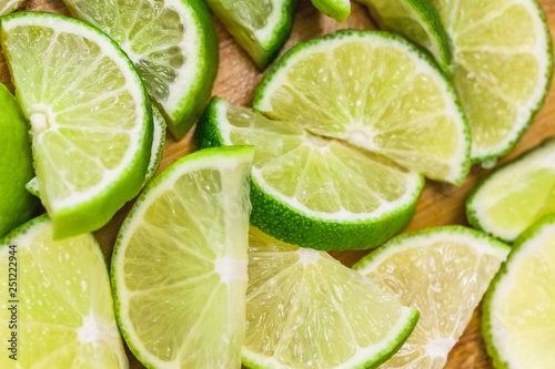 lime slices on wooden table, close up blurry background