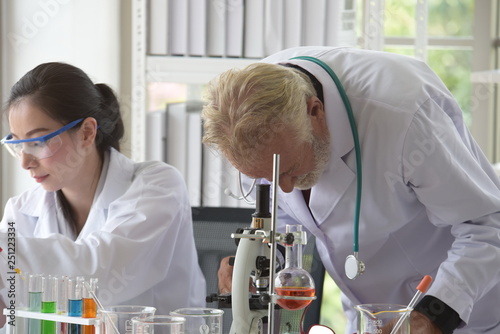 Scientists are working in science labs.Close-up of a scientistYoung female scientist looking through a microscope in a laboratory doing research, microbiological analysis, medicine. photo