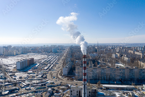Air pollution, factory pipes, smoke from chimneys on sky background. Concept of industry, ecology, steam plant, heating season, global warming. Factory chimney smoking, smoke emissions from chimneys