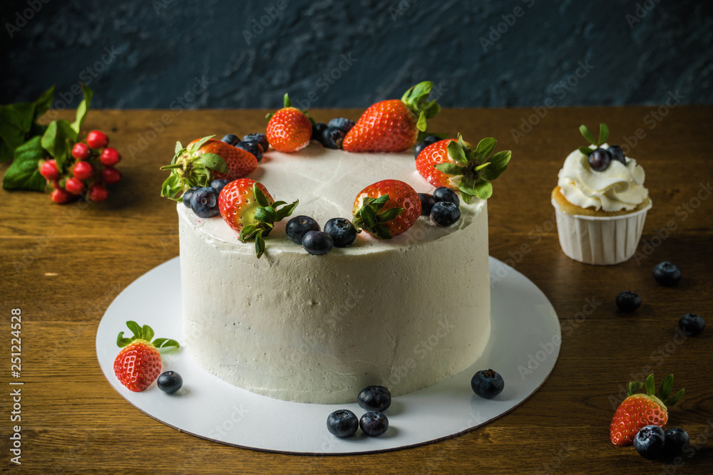 Delisious cakes with cream and berries an the dark stone background. Delisious cakes with cream and berries an the dark stone background.