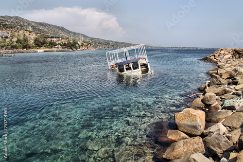 A half submerged fisherman boat is in Sokakagzi bay, Aegean Sea photo