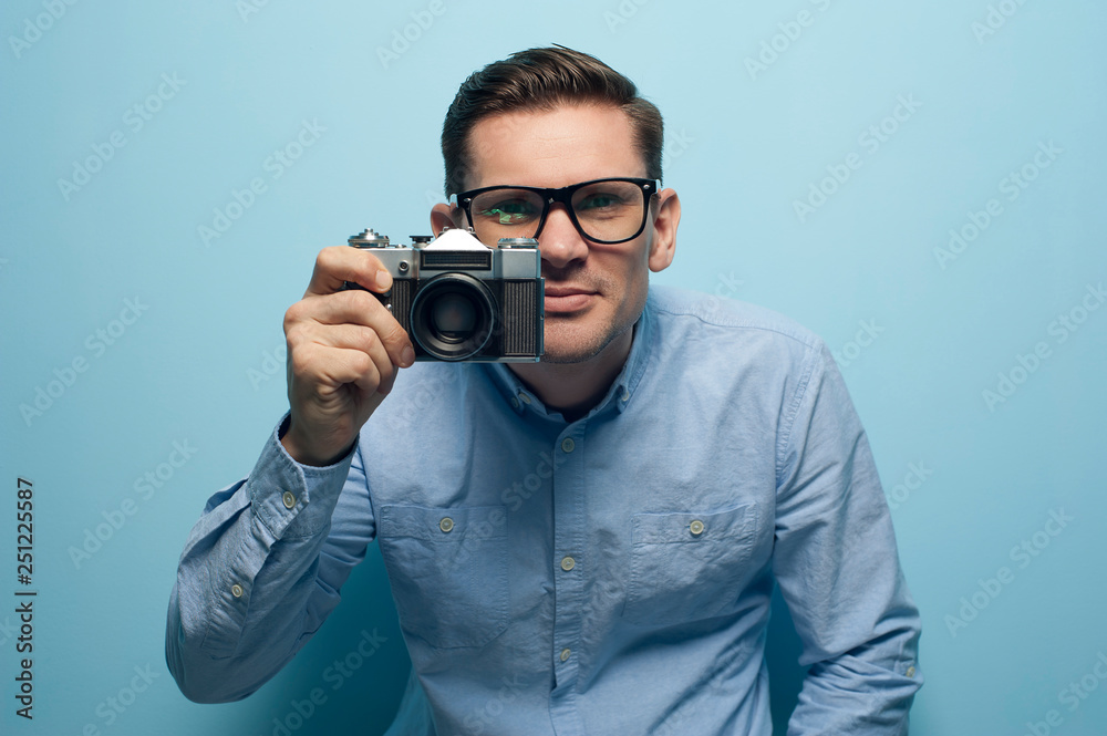 Young male photographer holding a new camera Young male photographer holding a new camera