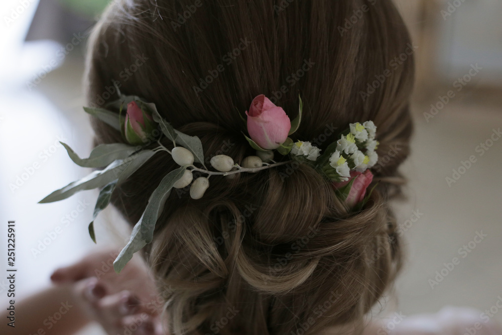 Naklejka premium Decoration in the hair of a woman from small pink roses, small white flowers and fruits Elaeagnus commutata