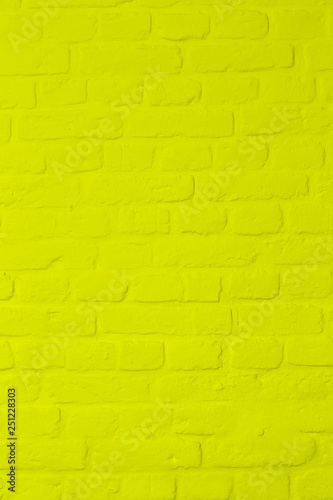 Pastel bright yellow colored brickstone wall