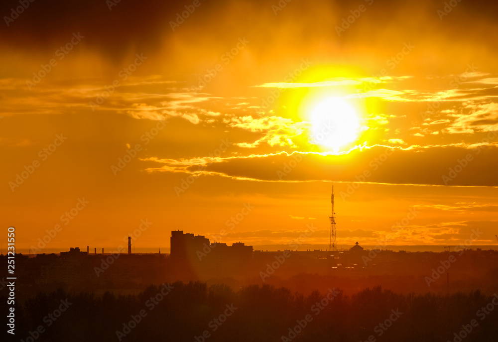 Naklejka premium Beautiful city sunset with a sun and clouds 