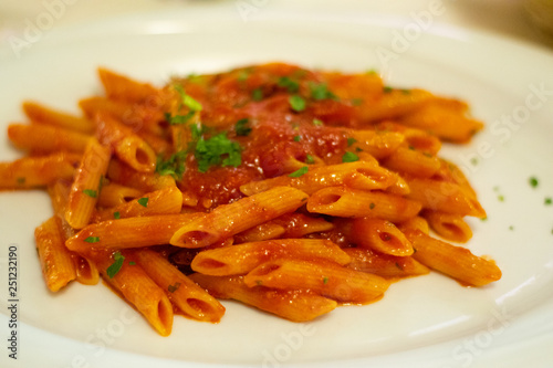 Penne Pasta With Red Sauce In A Bowl On A Table In A Restaurant In Rome, Italy.