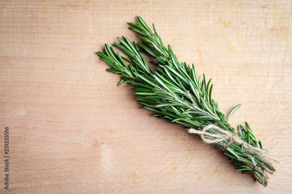 Fresh rosemary grass on a light board top view copy space Fresh rosemary grass on a light board top view copy space