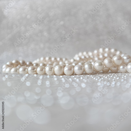 Nature white pearl beads on sparkling background