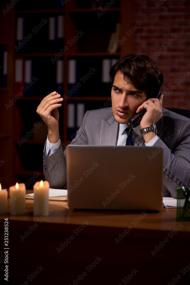 Businessman working late in office with candle light Businessman working late in office with candle light