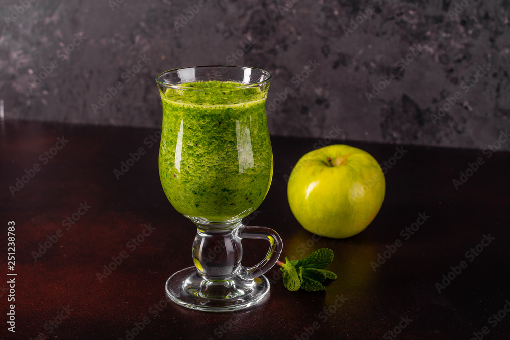 Fototapeta premium Ginger green apple smoothie on concrete background. It can be used as a background