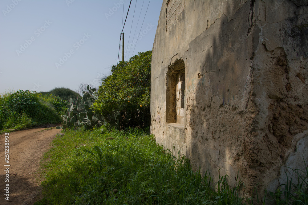 A building that was demolished and only remnants remain in the green field. A building that was demolished and only remnants remain in the green field.