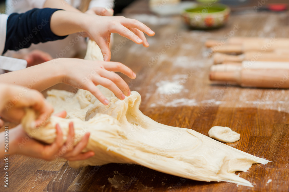 Young children make dough products. Hands closeup Young children make dough products. Hands closeup