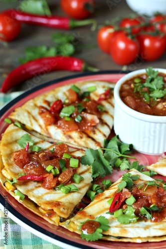 Quesadilla grill with spicy salsa with chili pepper. Mexican traditional food, wheat tortillas. 