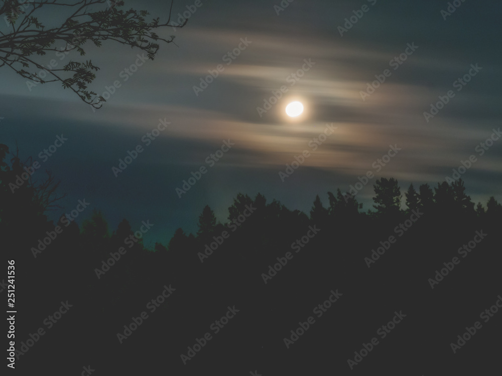 Moon in the night sky and moving clouds. long exposure shot Moon in the night sky and moving clouds. long exposure shot