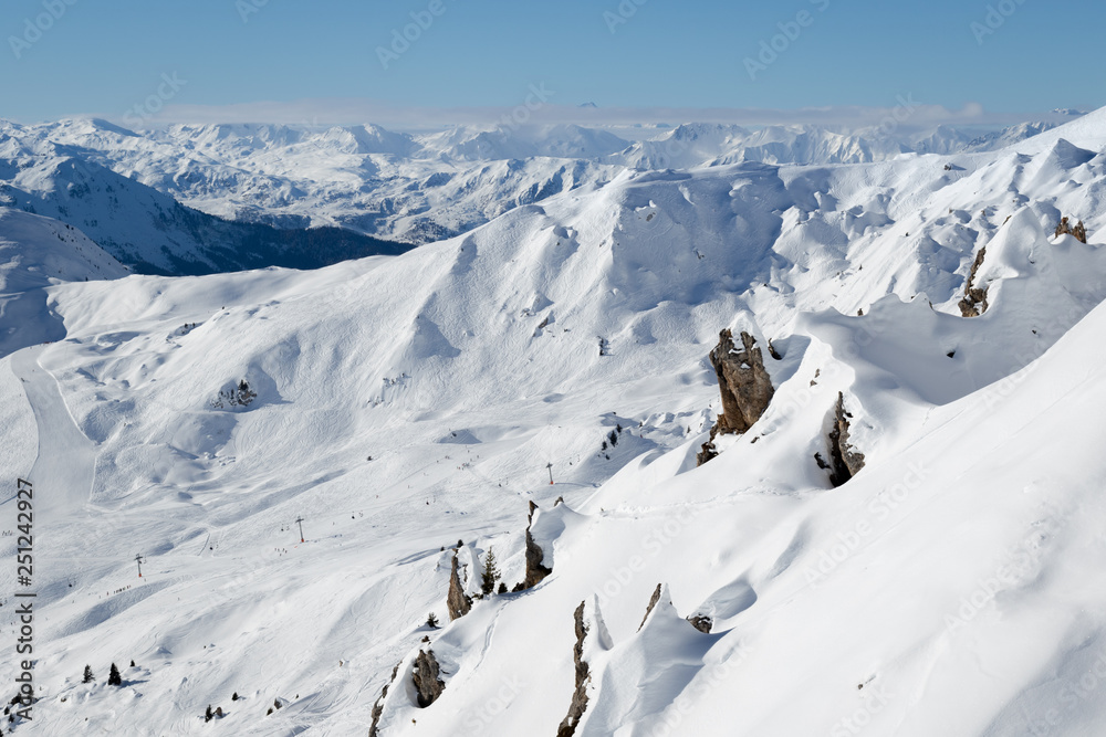 Beautiful view of snow covered rocks and mountains in the alpine ski resort La Plagne, France