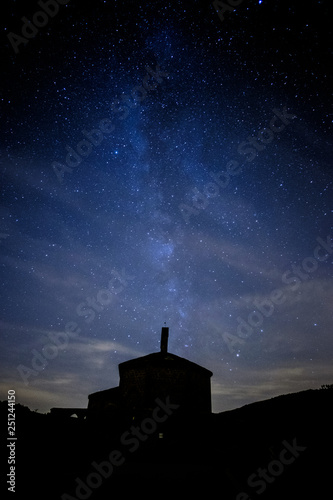 Milky way comming from Eunate church in a cloudy night near Pamplona, Spain