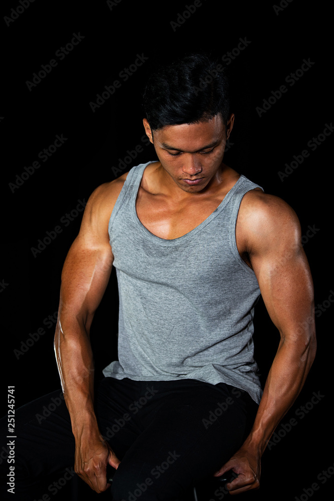 Asian muscle men posing muscle on the black background in black and white Asian muscle men posing muscle on the black background in black and white