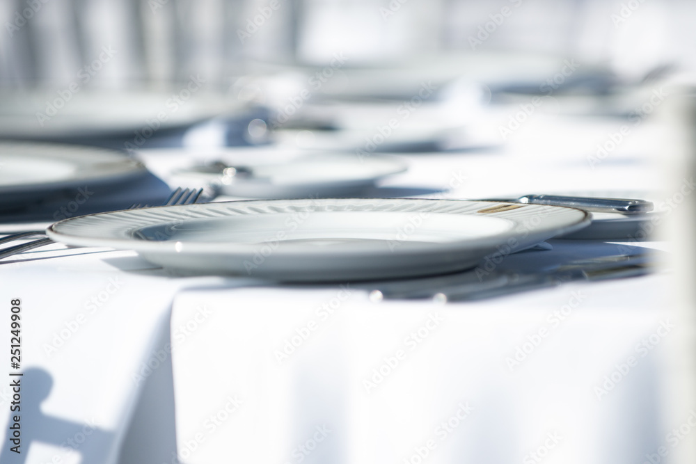 White plate on table with white tablecloth White plate on table with white tablecloth