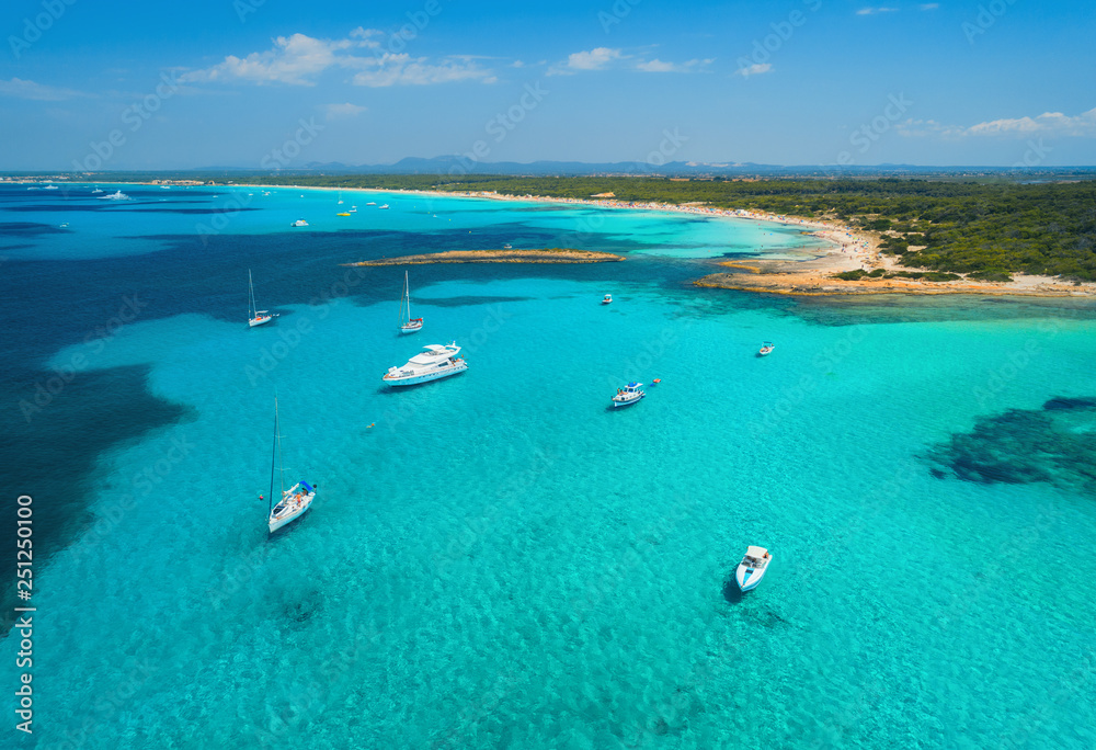Aerial view of boats and luxury yachts in the clear sea at sunset in summer in Mallorca, Spain. Colorful seascape with lagoon, azure water, sandy beach, blue sky. Balearic islands. Top view. Travel Aerial view of boats and luxury yachts in the clear sea at sunset in summer in Mallorca, Spain. Colorful seascape with lagoon, azure water, sandy beach, blue sky. Balearic islands. Top view. Travel