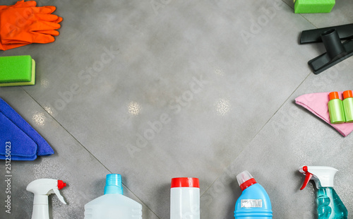 Cleaning products on the tile. House cleaning concept. View from above. Place for a logo lettering 