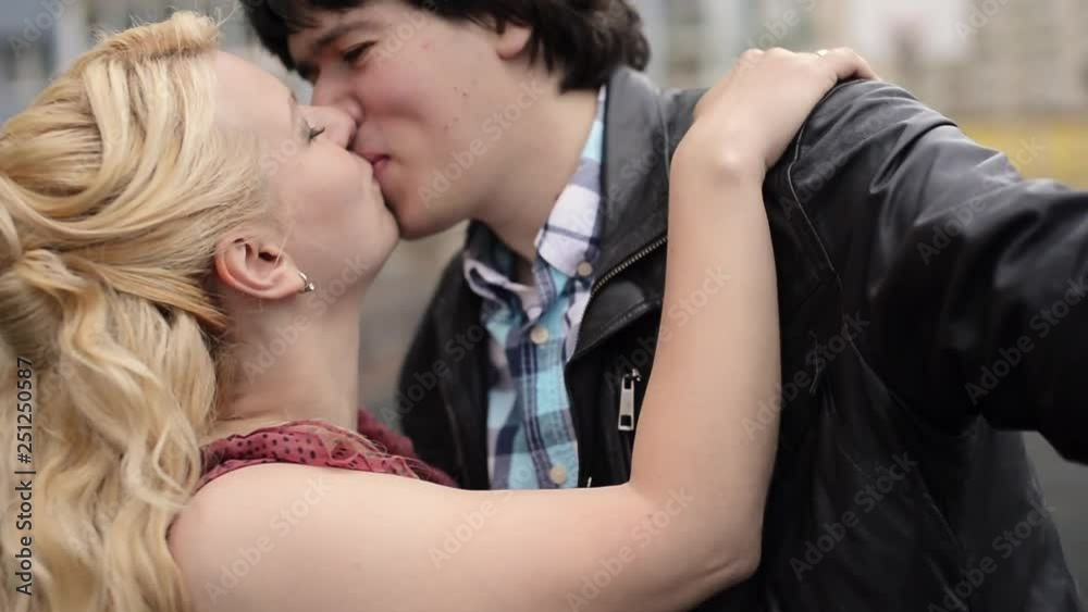 Young couple taking selfie on mobile phone having fun at the street. Young couple taking selfie on mobile phone having fun at the street.