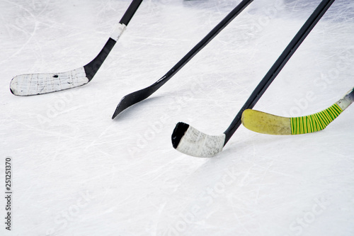 Four ice hockey sticks on the ice. Preparation for training in an open area