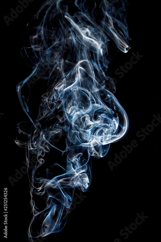 Close-up abstract beautiful smoke on a black isolated background. Blur and soft focus.
