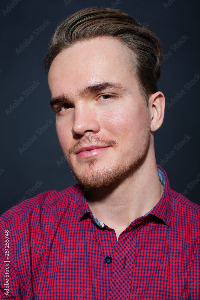 Obraz premium Studio portrait of young man on a dark background