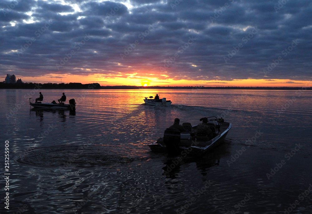 Fishermen Head Out in their Boats at Sunrise to Go Fishing