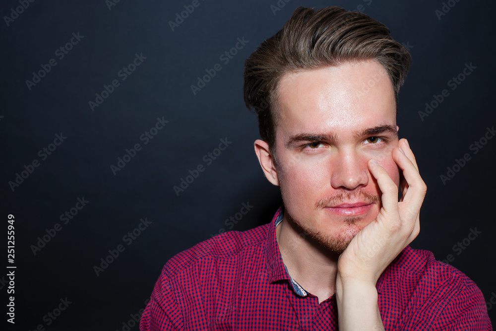 Studio portrait of young man on a dark background Studio portrait of young man on a dark background