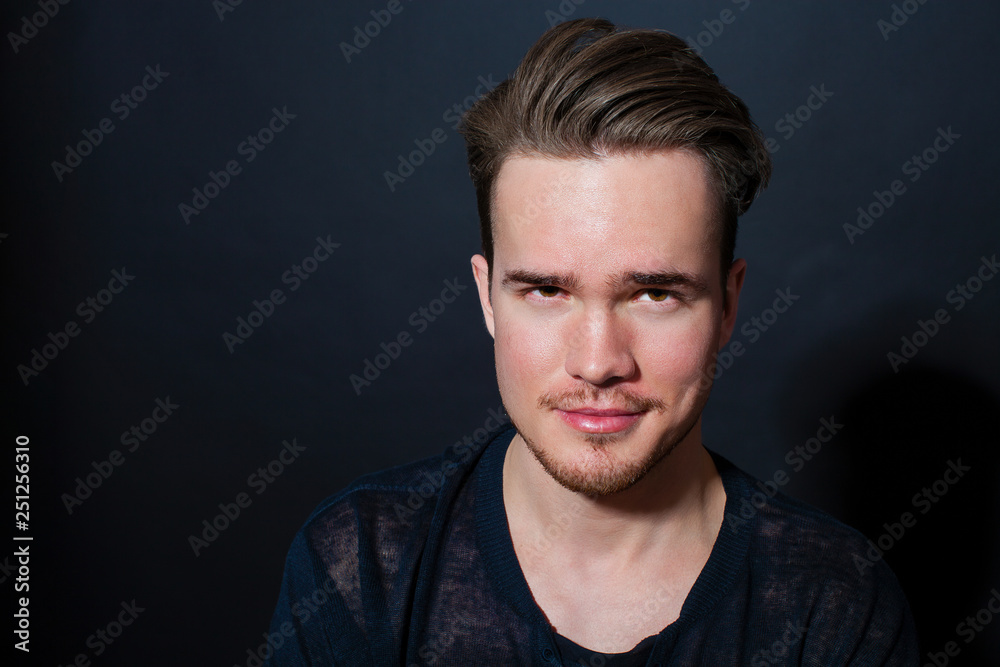 Studio portrait of young man on a dark background