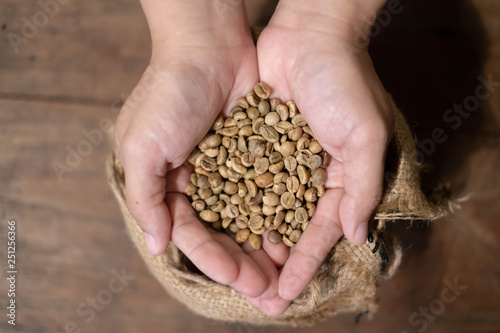 Close up of Coffee beans in hands.